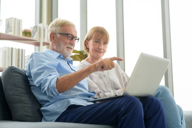 istock Happy Caucasian senior couple using laptop at home 1355306810