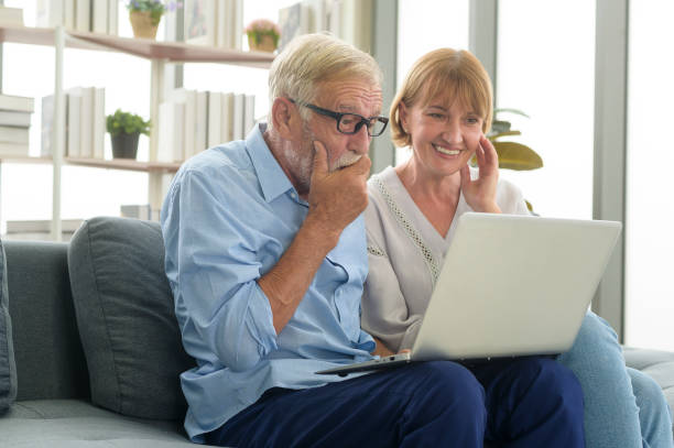 istock Happy Caucasian senior couple using laptop at home 1355306911