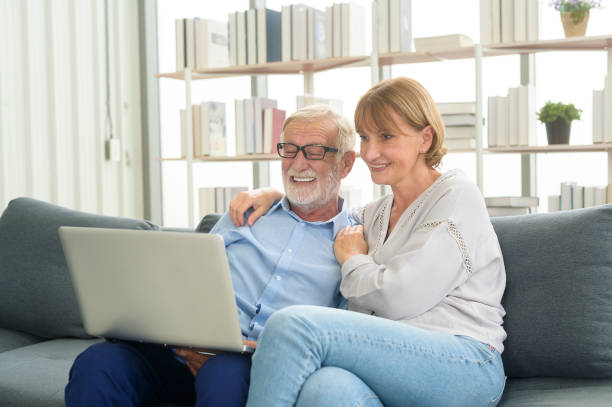 istock Happy Caucasian senior couple using laptop at home 1355306986