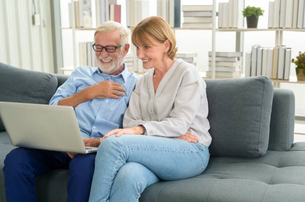 istock Happy Caucasian senior couple using laptop at home 1355307104