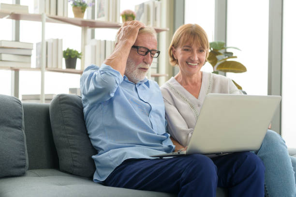 istock Happy Caucasian senior couple using laptop at home 1355307135