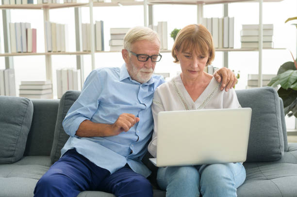 istock Happy Caucasian senior couple using laptop at home 1355307154