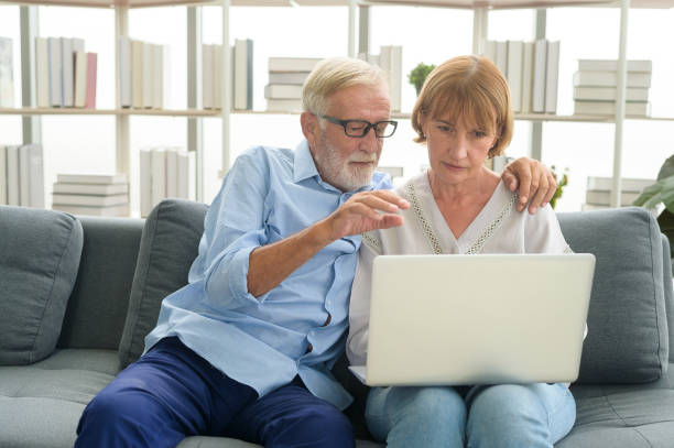 istock Happy Caucasian senior couple using laptop at home 1355307318