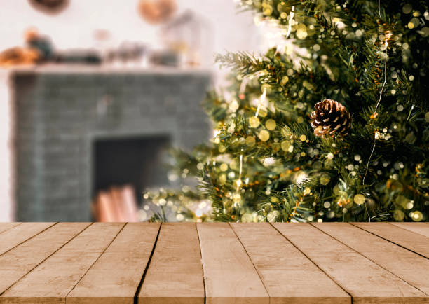 empty christmas table background with christmas tree out of focus for product display montage.