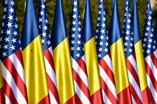 Romania and United States Of America national flags are seen during an official ceremony