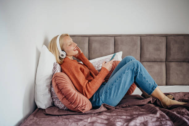 istock Listening music using wireless headphone 1355308916