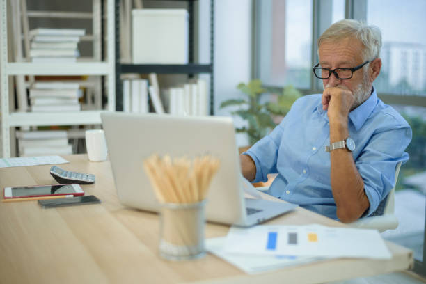 istock Caucasian senior Businessman working in modern office 1355309635
