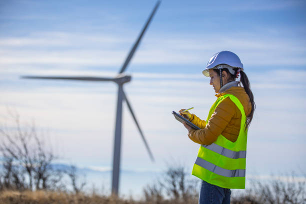 istock Female wind energy engineer working in wind farm. Renewable Energy. 1355311140