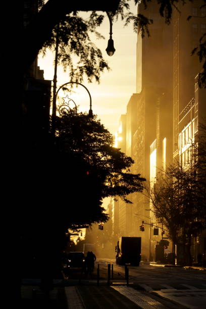 istock Old World Manhattan is reflected in an early morning streetscape. 1355311393
