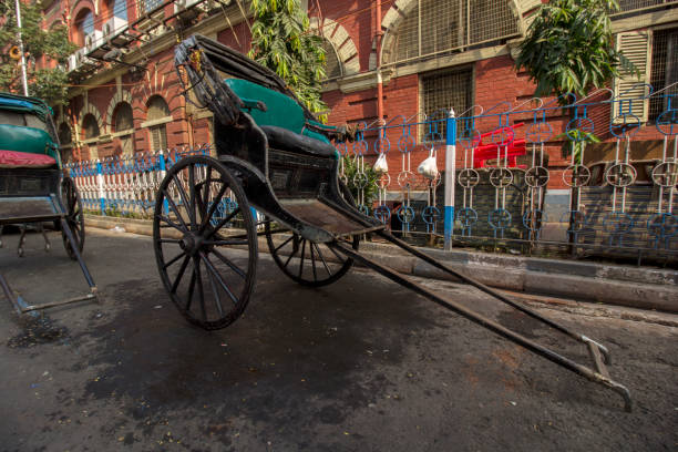 istock Famous hand pulled rickshaws parked road side on streets of Kolkata 1355311784