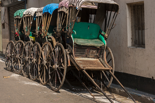 Few famous hand pulled rickshaw parked road side on streets of Kolkata