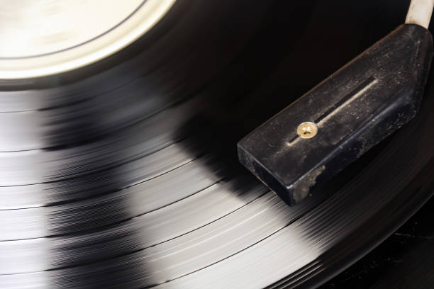 istock Black vinyl record spinning on the turntable. Analog audio playback 1355316450