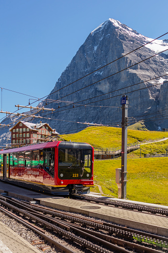 Interlaken, Switzerland - August 23, 2016: In the Kleine Scheidegg station, along the railway that takes tourists from Interlaken to Jungfraujoch (3,466 m - 11,371 ft). In the background, the north face of the Eiger (3,970 m - 13,020 ft).