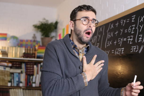 Shocked looking teacher in classroom Shocked looking teacher in classroom. comedian photos stock pictures, royalty-free photos & images