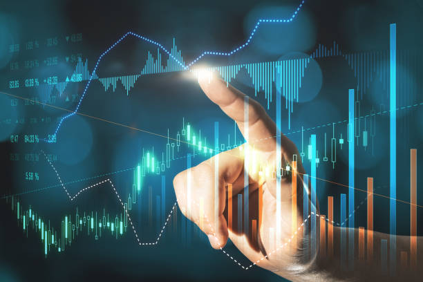 istock Businessman hand pointing at creative glowing forex graph on blurry bokeh background. Market analysis and trade concept. Double exposure. 1355318241