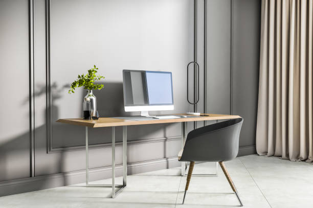 istock Modern interior with creative designer desktop, computer screen, decorative plant and concrete flooring. 3D Rendering. 1355318426