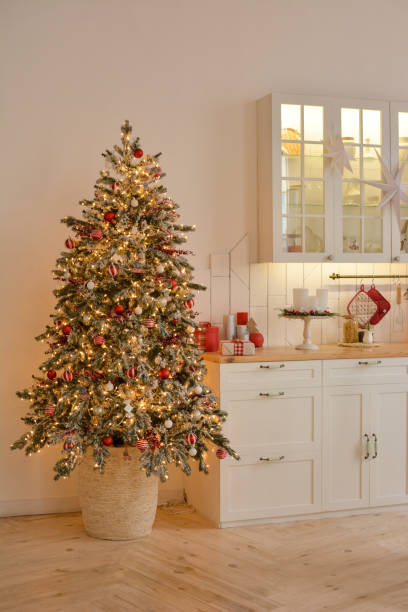 istock Interior of a light white ?hristmas kitchen with red decor elements in the Scandinavian style. Christmas decorations. Breakfast 1355318497