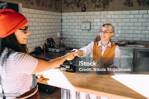 istock Pays with plastic card in cafe for lunch 1355318573