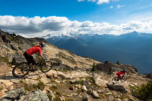Couple mountain biking in Whistler Canada. Whistler bike parks Top of the World.