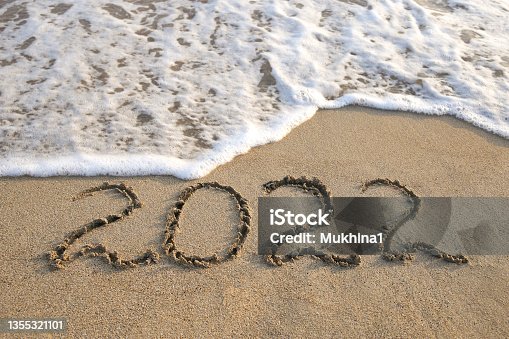 istock 2022 year written on sandy beach sea. Top view. Flat lay. 1355321101