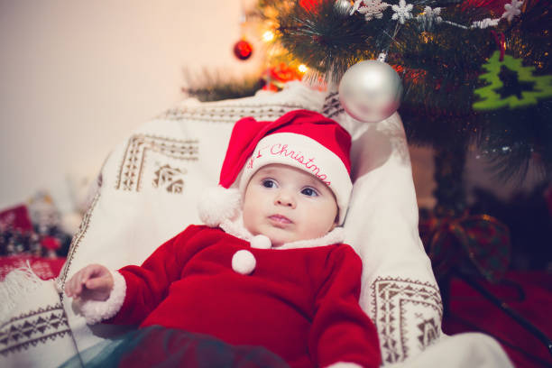 istock Baby resting at Christmas tree 1355323391
