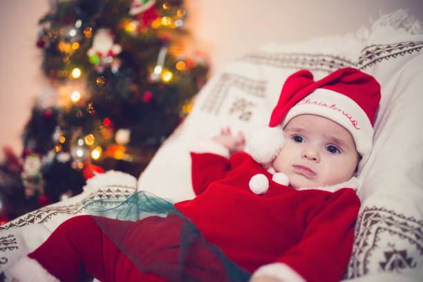 istock Baby resting at Christmas tree 1355323397