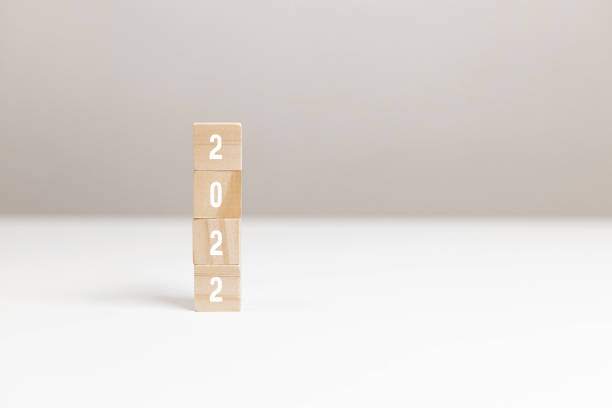 istock Wooden blocks with message 2022 Number on white table on light background. New Year's composition 1355324048