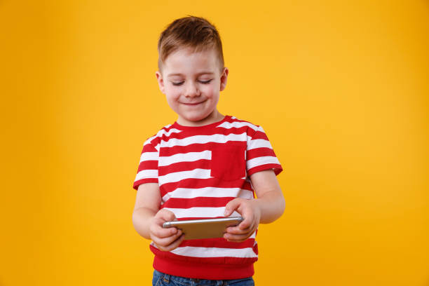 istock Boy playing games or surfing internet on digital smartphone 1355324162