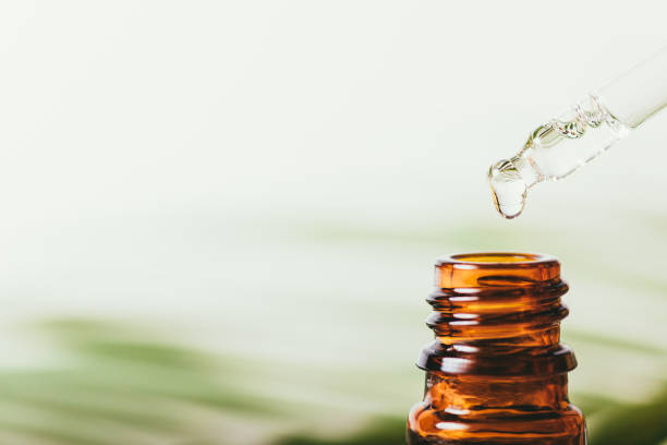 istock Drop clear essential oil drips from pipette 1355324627