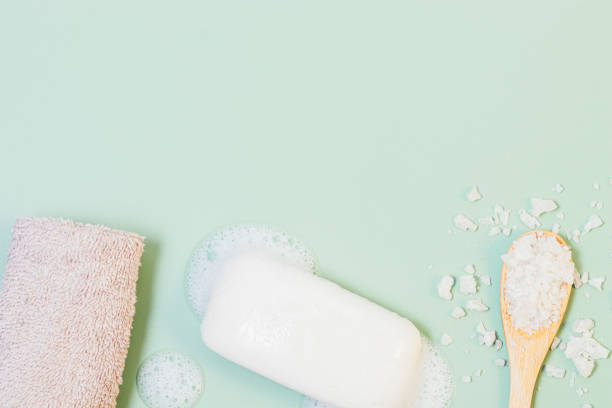 istock Soap bar with bubble foam next to terry towel and bath salt 1355324727
