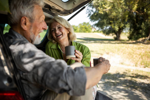 istock Romantic Senior couple having coffee in nature smiling having fun 1355327163