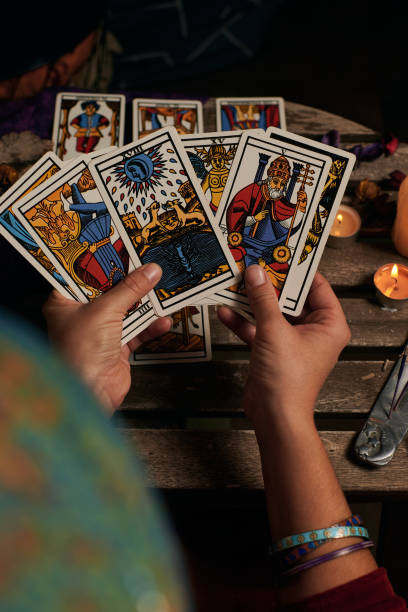 istock Close-up of a fortune teller reading tarot cards 1355328018