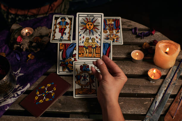 istock Close-up of a fortune teller reading tarot cards 1355328019