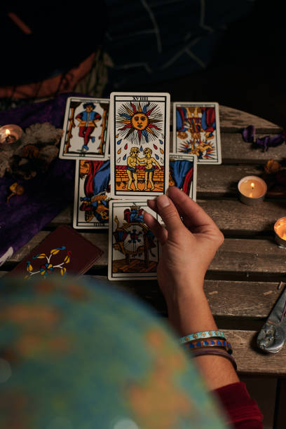 istock Close-up of a fortune teller reading tarot cards 1355328020