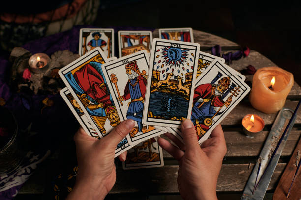 istock Close-up of a fortune teller reading tarot cards 1355328026