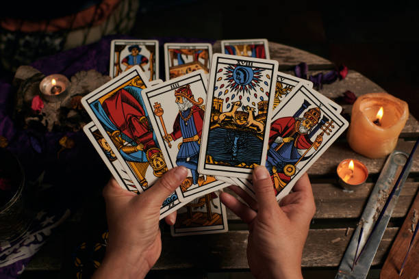 Close-up of a fortune teller reading tarot cards Close-up of a fortune teller reading tarot cards cristian stock pictures, royalty-free photos & images