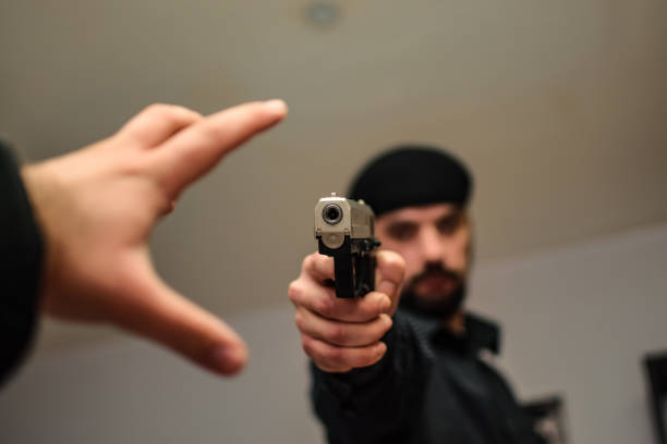 istock Young armed detective working on a case in apartment where potential murder has occured 1355329436