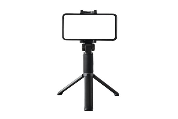 Smartphone and mini tripod isolated on white Smartphone on black tripod with blank screen isolated on white background. Copy space. Vlogging, streaming, social media content. Content creating tripod stock pictures, royalty-free photos & images