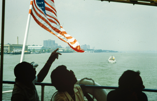 NEW YORK, UNITED STATES MAY 1970: People point to the American flag in 70's