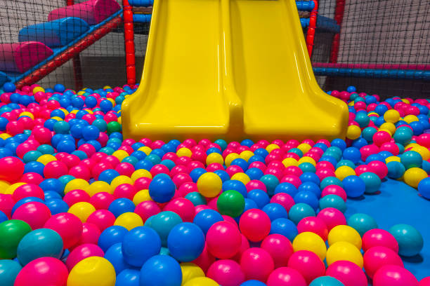 close up view of playing in pool with plastic balls and slide on indoor playground in activity center. sweden. - ball pool imagens e fotografias de stock