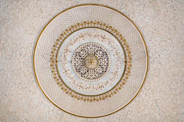 Architectural detail closeup of islamic style circular patterns of interior ceiling lamp fittings