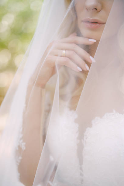 istock Bride in a white dress, covered with a veil. Portrait 1355336921