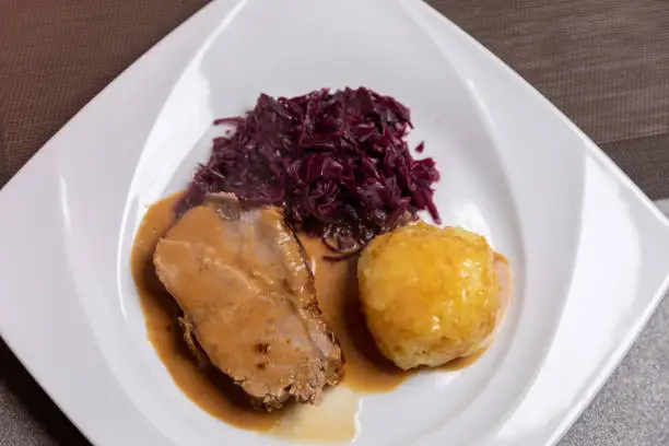 Roast pork with potato dumplings and red cabbage. Home made food, christmas dinner