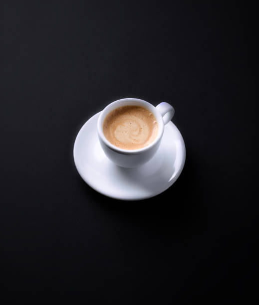 istock Cup of coffee on black paper background. Copy space. 1355338212