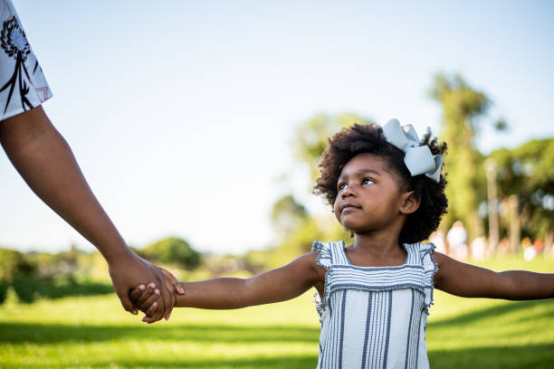 istock African american child looking at his mother 1355338272