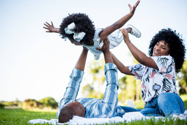 istock Black family having fun in the park 1355338314