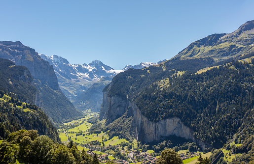 Lauterbrunnen, Switzerland - August 23, 2016: Village of Lauterbrunnen and its valley (Lauterbrunnental), with the well-known Staubbach Waterfall.