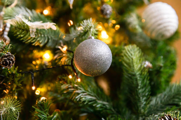 istock Classic Christmas decorated New year tree. Christmas tree with wite and silver decorations, ornaments toy and ball. Modern classical style interior design apartment. Christmas eve at home 1355340821