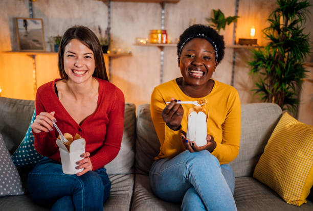 istock Friends are eating and watching TV show 1355344308
