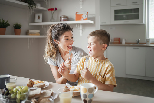 Shot of a young mother and her son having fun while enjoying breakfast together at home